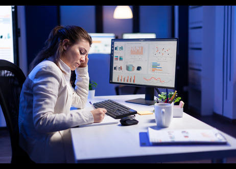a tensed lady at her desk looking at CX stats